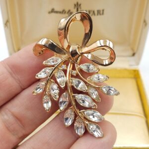 Spilla Trifari, risalente ai primi anni '50, realizzata in lega Trifanium color oro con cristalli diamante taglio navette, decoro con fiocco - VINTAGE AMORE MIO