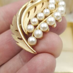 Spilla Trifari risalente al 1960 circa, decoro botanico, realizzata in lega Trifanium color oro satinato con particolari lucidi e perle - VINTAGE AMORE MIO